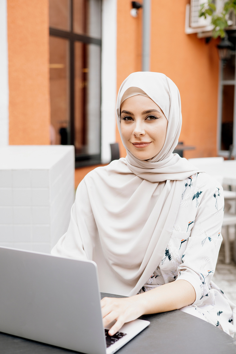 Beautiful Woman Wearing Hijab Using a Laptop
